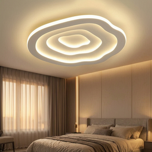 Lámpara de techo LED Ripple encendida en un dormitorio