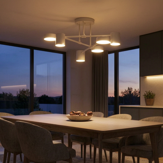 Lámpara colgante geométrica encendida sobre una mesa de comedor